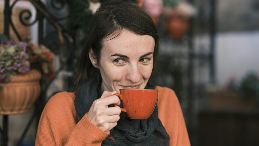 A woman enjoying a warm cup of coffee